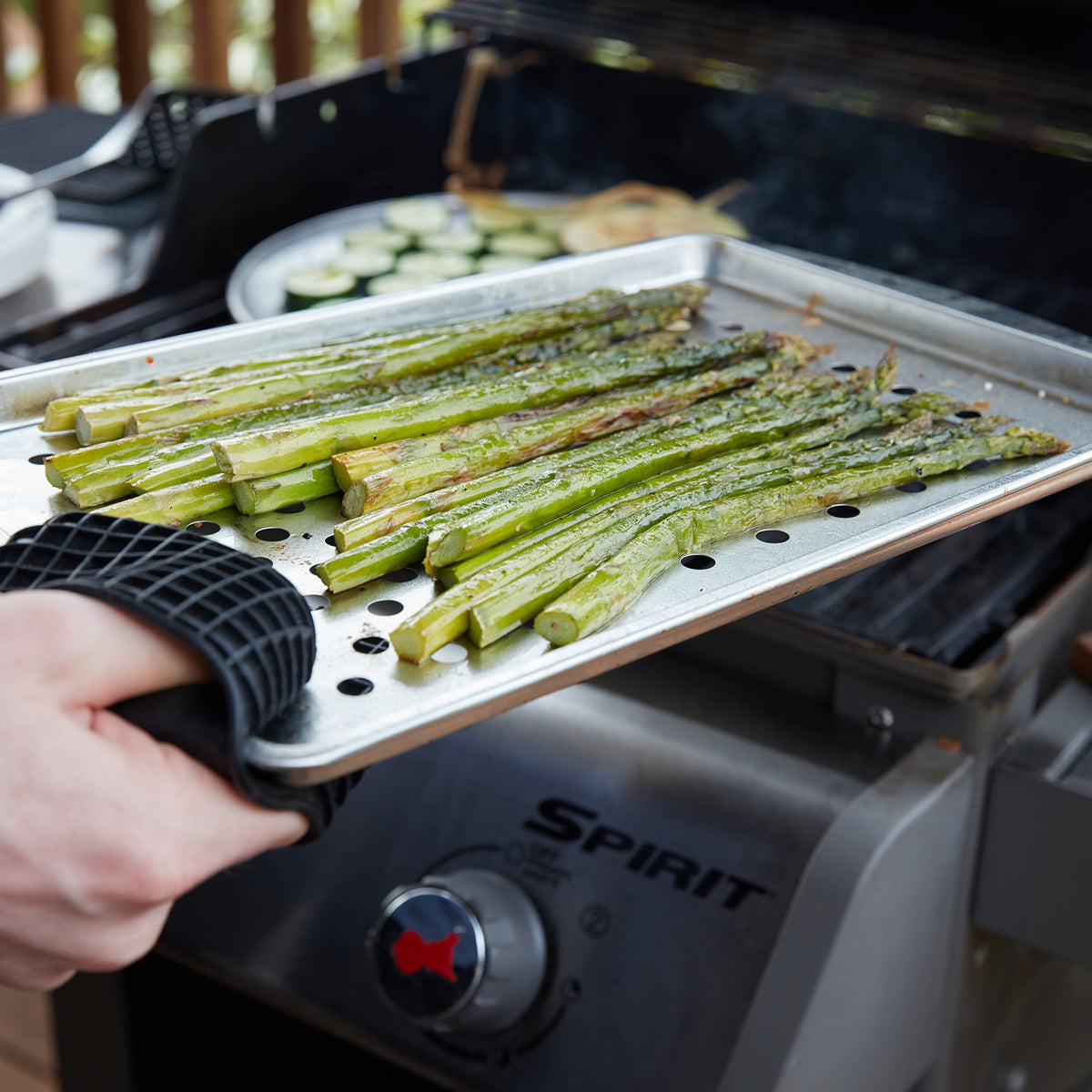 Lifestyle photo, shows asparagus spears fresh off the grill, having been roasted on the medium grill top tray.