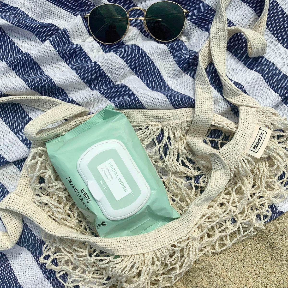 Lifestyle photo, net market tote being used to carry a beach towel, facial wipes, and other beachgoing sundries to and from the beach, leaving all that pesky sand behind!