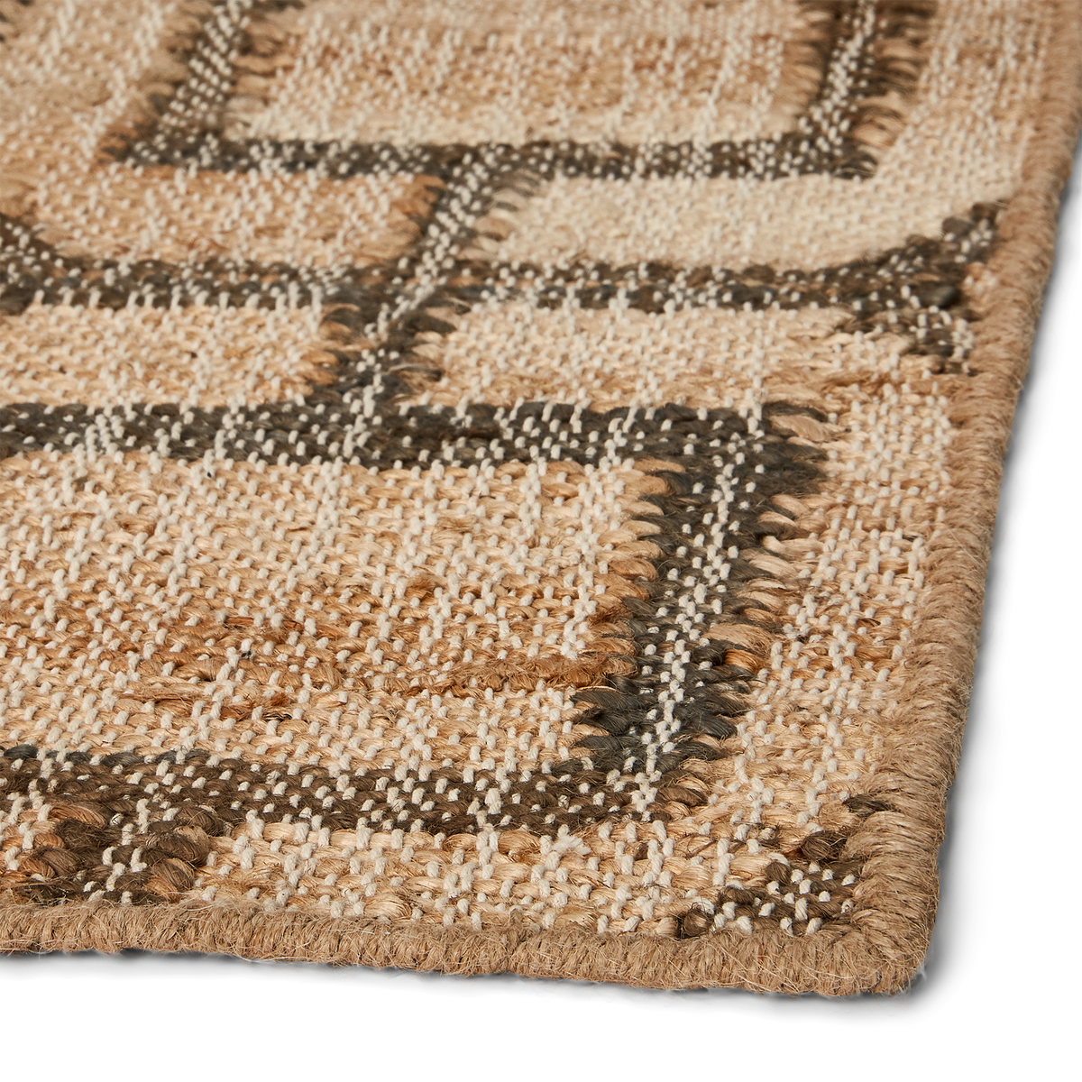 Detail view of runner corner, showing fully stitched and clean corner, consistent weave, and blend of natural earthtone colors.
