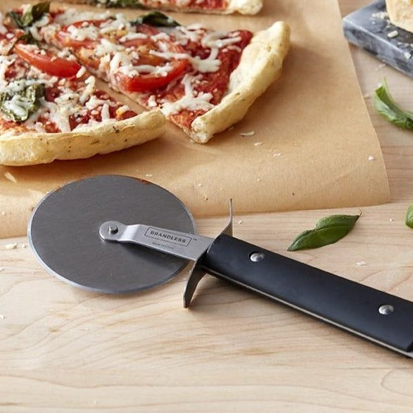 Pizza cutter shown next to a fresh homemade pizza