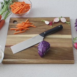 Video, woman's hands holding a nakiri knife and demonstrating a single-downward-stroke chopping technique with the nakiri knife on a quartered cabbag on a cutting board.