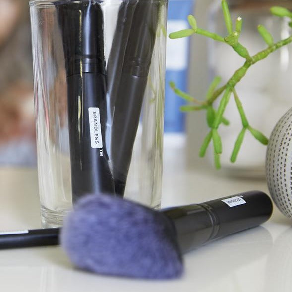 Lifestyle, set of brandless makeup brushes on a bathroom counter and in a glass container.